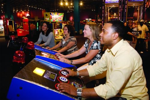 adults playing arcade games in houston
